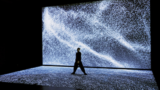 Performers' shadows on the glowing stage